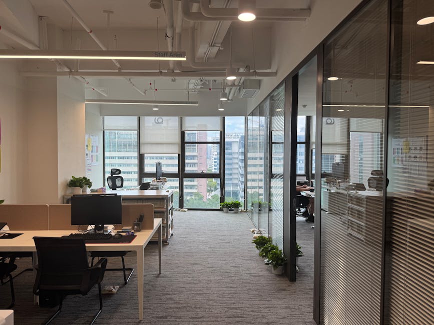 Bright, modern office interior with large windows and open workspace design.